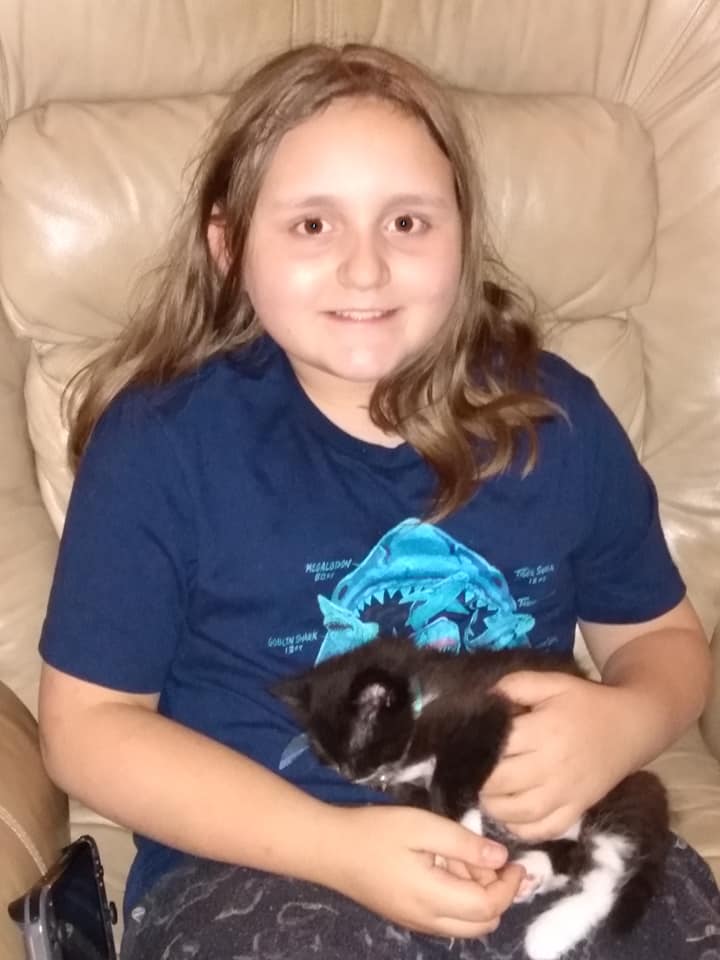 Emmaliese is holding her cat, Olive